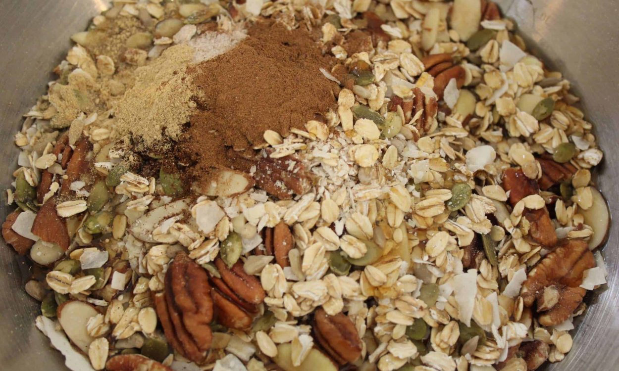 granola step 3 bowl with granola mixture and spices and salt added