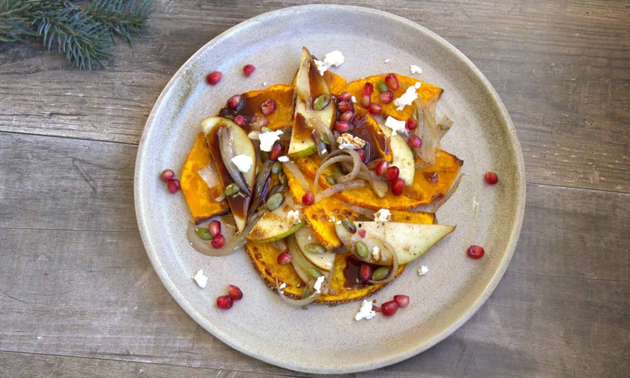 squash and pear salad v1 plate with roasted squash, shallots, pears, goat cheese, pomegranate seeds and a drizzle of balsamic reduction
